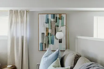 a living room with a couch and a picture on the wall at Westlake Apartment in Westlake