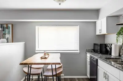 a kitchen with a table and chairs in a kitchen at Westlake Apartment in Westlake