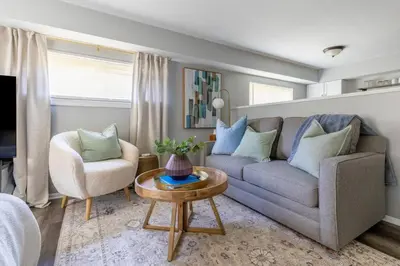 a living room with a couch and a chair and a table at Westlake Apartment in Westlake