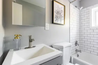 a white bathroom with a sink and a toilet at Westlake Apartment in Westlake
