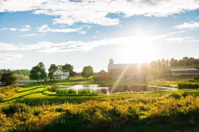 a view of a farm with a pond and buildings at Downtown Escape Great for large families & groups in Sugarcreek