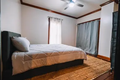 a bedroom with a bed and a window at Downtown Escape Great for large families & groups in Sugarcreek
