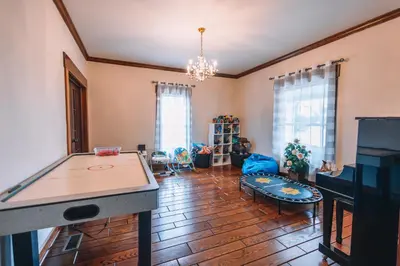 a living room with a ping pong table at Downtown Escape Great for large families & groups in Sugarcreek