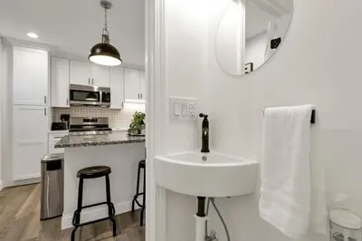 a white kitchen with a sink and a counter at The Worthington - 3 BR 2 5 Bath and Parking in Columbus