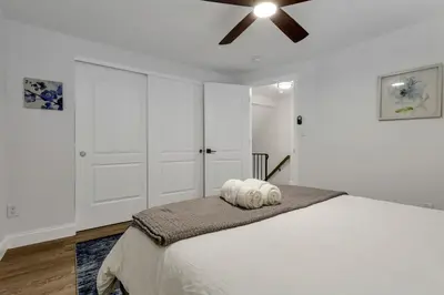 a bedroom with a bed with a ceiling fan at The Worthington - 3 BR 2 5 Bath and Parking in Columbus