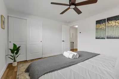 a bedroom with a bed with a ceiling fan at The Worthington - 3 BR 2 5 Bath and Parking in Columbus