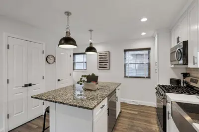 a kitchen with white cabinets and a counter top at The Worthington - 3 BR 2 5 Bath and Parking in Columbus