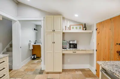 a kitchen with white walls and a pantry at Bell Street by the Falls in Chagrin Falls