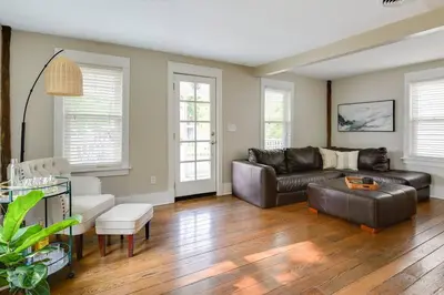 a living room with a couch and a table at Bell Street by the Falls in Chagrin Falls