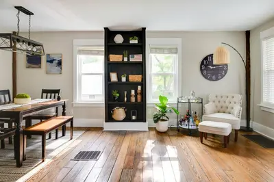 a living room with a table and a dining room at Bell Street by the Falls in Chagrin Falls