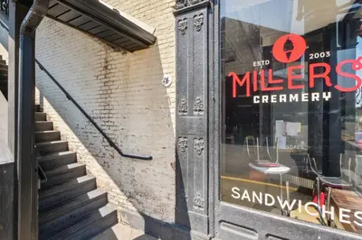 a store window with a sign on the side of a building at Sleek Millersburg Apartment in Downtown! in Millersburg