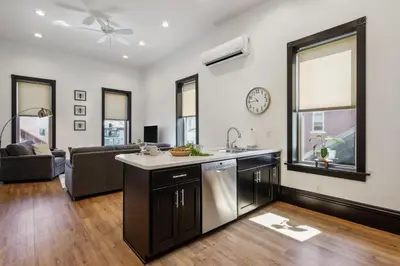an open kitchen and living room with a couch at Sleek Millersburg Apartment in Downtown! in Millersburg