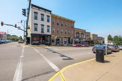 an empty street in a small town with a traffic light at Sleek Millersburg Apartment in Downtown! in Millersburg