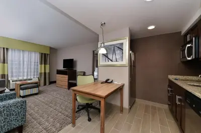 a hotel room with a desk and a room at Homewood Suites by Hilton Cincinnati/Mason in Mason