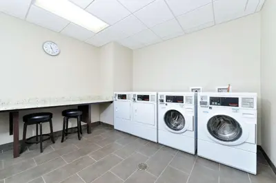 a laundry room with two washing machines and a counter at Homewood Suites by Hilton Cincinnati/Mason in Mason