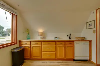 a kitchen with wooden cabinets and a window at Lakefront St Marys Getaway with Boat Dock and Fire Pit in Southmoor Shores