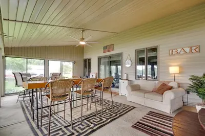 a living room with a couch and a table and chairs at Lakefront St Marys Getaway with Boat Dock and Fire Pit in Southmoor Shores