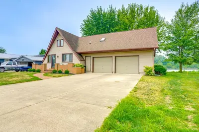 a house with a driveway and a garage at Lakefront St Marys Getaway with Boat Dock and Fire Pit in Southmoor Shores