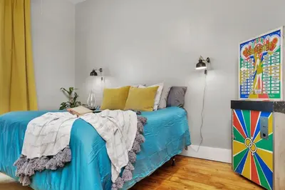 a blue couch in a room with a painting at Enchanting Bungalow - 2BR Historic Hidden Gem in Xenia