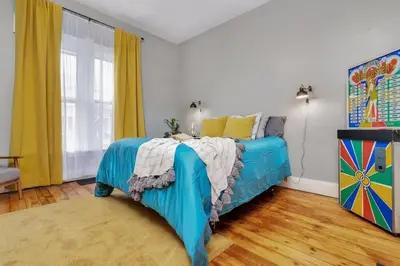 a bedroom with a blue bed and a window at Enchanting Bungalow - 2BR Historic Hidden Gem in Xenia
