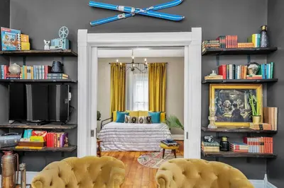 a bedroom with a bed and a clock on the wall at Enchanting Bungalow - 2BR Historic Hidden Gem in Xenia