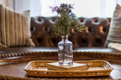 a vase with flowers on a tray on a table at Enchanting Bungalow - 2BR Historic Hidden Gem in Xenia