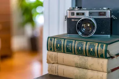 a camera sitting on top of some books at Enchanting Bungalow - 2BR Historic Hidden Gem in Xenia
