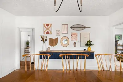 a dining room with a table and three chairs at The Bird Cage in Xenia
