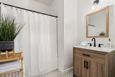 a bathroom with a white shower curtain and a sink at The Bird Cage in Xenia