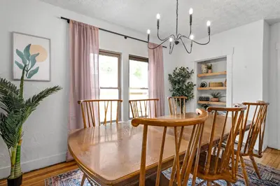 a dining room with a wooden table and chairs at The Bird Cage in Xenia