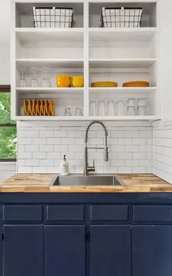 a kitchen with a blue sink and white cabinets at The Bird Cage in Xenia