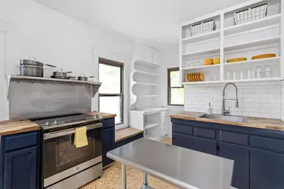 a kitchen with blue cabinets and a sink at The Bird Cage in Xenia