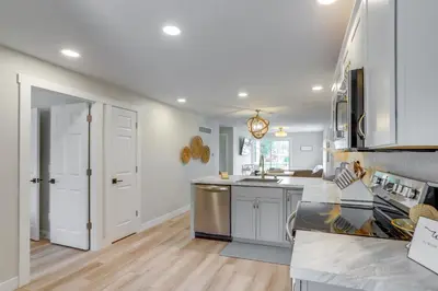 a kitchen with white cabinets and a counter top at Port Clinton Vacation Rental with Boat Dock and Grill! in Port Clinton