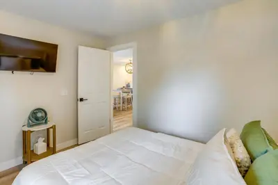 a bedroom with a white bed and a table at Port Clinton Vacation Rental with Boat Dock and Grill! in Port Clinton
