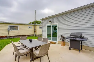 a patio with a table and a grill and chairs at Port Clinton Vacation Rental with Boat Dock and Grill! in Port Clinton