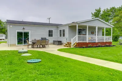 a house with a patio and a table and chairs at Port Clinton Vacation Rental with Boat Dock and Grill! in Port Clinton