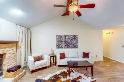 a living room with a couch and a ceiling fan at Dog-Friendly Yard! Family Retreat in Fort Wayne in Sunnybrook Acres