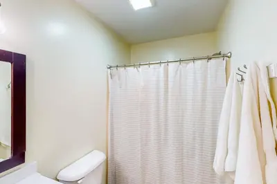a bathroom with a shower with a white shower curtain at Dog-Friendly Yard! Family Retreat in Fort Wayne in Sunnybrook Acres