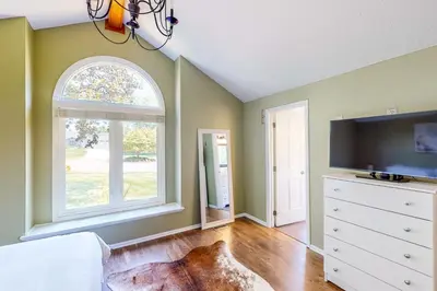 a bedroom with a dresser and a large window at Dog-Friendly Yard! Family Retreat in Fort Wayne in Sunnybrook Acres