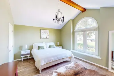 a bedroom with a bed and a chandelier at Dog-Friendly Yard! Family Retreat in Fort Wayne in Sunnybrook Acres