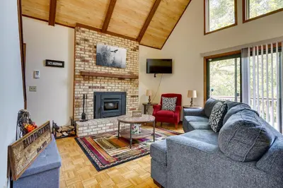 a living room with a couch and a fireplace at Cabin with Deck about 3 Mi to Apple Valley Lake! in Mount Vernon