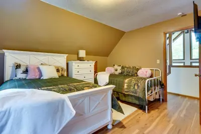 a bedroom with two twin beds and a dresser at Cabin with Deck about 3 Mi to Apple Valley Lake! in Mount Vernon
