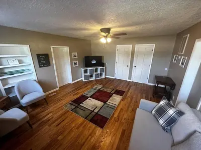 a living room with a couch and a tv at Entire Home in Cambridge City in Cambridge City