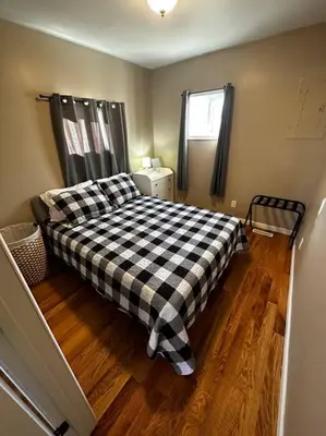 a bedroom with a black and white checkered bed at Entire Home in Cambridge City in Cambridge City