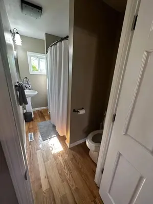 a bathroom with a shower and a toilet and a sink at Entire Home in Cambridge City in Cambridge City