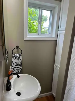 a white sink in a bathroom with a window at Entire Home in Cambridge City in Cambridge City