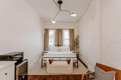 a bedroom with two beds in a white room at East Main Lofts in Madison