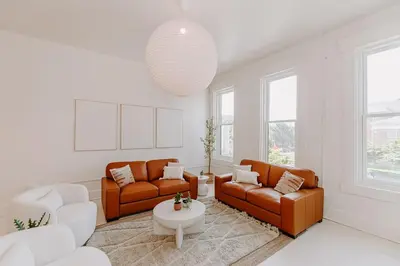 a living room with two couches and a table at East Main Lofts in Madison