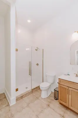 a bathroom with a shower and a toilet and a sink at East Main Lofts in Madison
