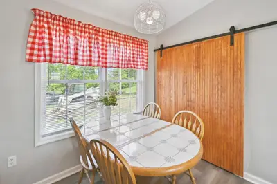 a dining room with a table and chairs and a window at Corinth Getaway with Deck about 11 Mi to Ark Encounter! in Corinth